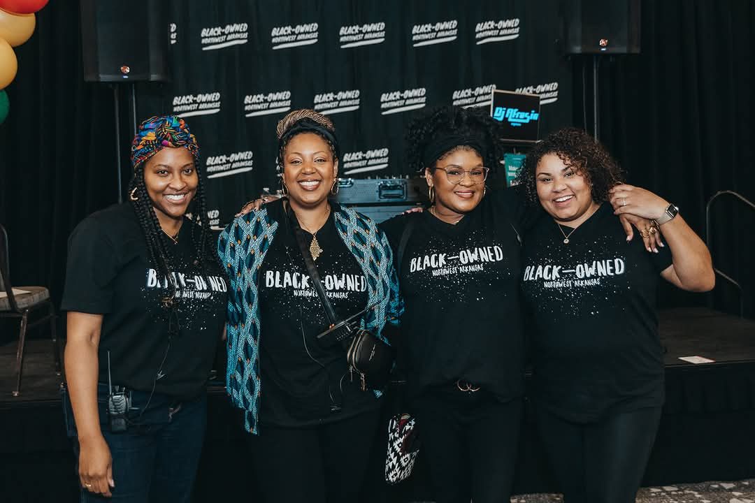 The Black-Owned NWA team standing together in front of the Expo backdrop